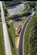 Crews build a drainage pond between the southbound lanes of I-75 and the new 2-lane ramp to I-4.