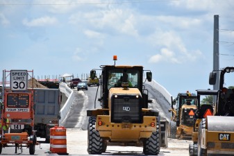 Construction is very busy on the ramp and bridge that will take westbound Overpass Road traffic onto southbound I-75 (photo 7/6/2022)