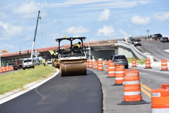 Asphalt paving on westbound Overpass Road and construction on the flyover bridge onto southbound I-75 (8/15/2022 photo)