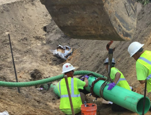 Workers install a force main pipe (August 4, 2020 photo)