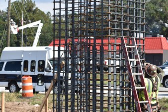 A worker ties rebar in one of the foundations for the pedestrian bridge in the southeast corner of Cortez Blvd. and Cobb Road (11/3/2022 photo)