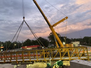 A crane prepares to lift truss for pedestrian bridge (5-25-2023 photo)
