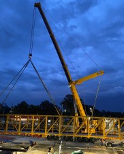 A crane begins to lift truss for pedestrian bridge (5-25-2023 photo)