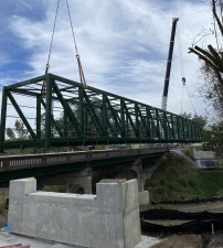 The first section of the trail's pedestrian bridge is lifted into place over the railroad tracks next to S Broad Street (11/28/2023 photo)