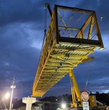A crane positions the steel pedestrian bridge into place over Cortez Blvd. (5-25-2023 photo)