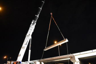 A crane lifts a concrete beam into place at SR 60 and I-275 (3/21/2020 photo)