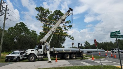 Preparing to offload a signal pole on the west side of US 19 (8/17/2022 photo)