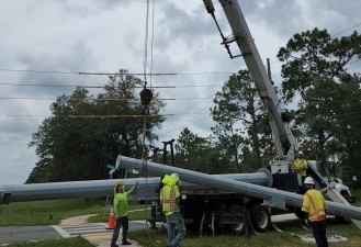 Offloading a signal pole from the transport truck (8/17/2022 photo)