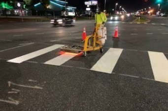 Installing thermoplastic paint striping for a crosswalk at Continental Drive and US 19 (4/8/2021 photo)