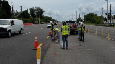 Sawcutting existing asphalt pavement for proposed concrete traffic separator (June 2026 photo)