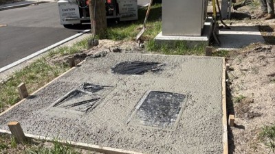 Concrete pour on southwest corner mow pads on SR 574 (W Martin Luther King Jr Boulevard) at N 12th Street (May 2026 photo)
