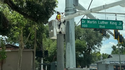 Tightening bolts on the illuminated sign bracket (June 2026 photo)