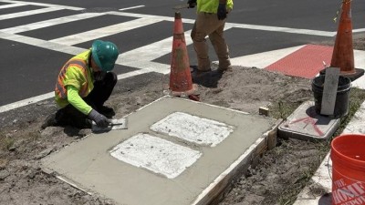 Crews finishing concrete for mow pad (June 2026 photo)