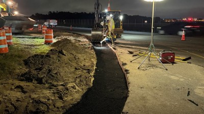 Crews pour the asphalt curb pad on SR 580 at Eisenhower Blvd (April 2026 photo)