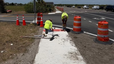 Installing pedestrian detectable warning mats (May 2026 photo)