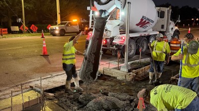 Crews pour concrete for sidewalk (September 2026 photo)