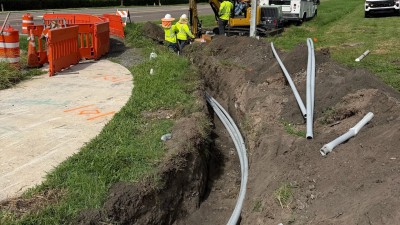 Installing PVC conduit runs at the NE corner (July 2026 photo)