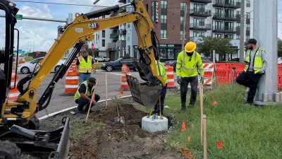 Installing a ped pole base at the NE corner (July 2026 photo)