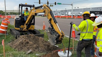 Installing a ped pole base at the NW corner (July 2026 photo)