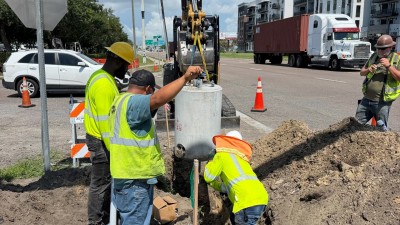 Installing a ped pole base at the SE corner (July 2026 photo)