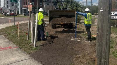 Placing millings for temporary pedestrian walkways (March 2026 photo)