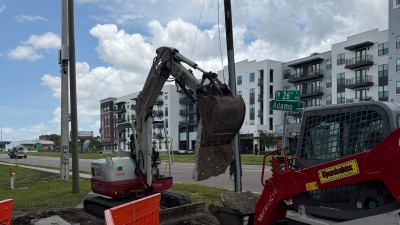 Removing existing concrete sidewalk at the SW corner (July 2026 photo)