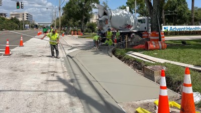 Poured sidewalk at the SW corner (August 2026 photo)