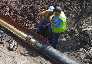 Welding a sleeve around an existing water main crossing new northbound US41 (10/11/2021 photo)