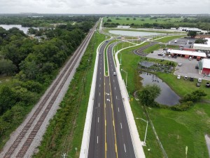 Looking south over the US 98 Bypass to the roundabout at Old Lakeland Highway at final paving and marking (6-1-2026 photo)