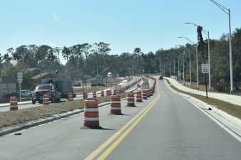 Northbound and southbound traffic is separated by a median. Looking west towards the roundabout at 7th Street (2-5-2026 photo)
