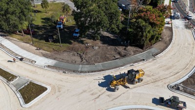 Fine-grading lime rock in the roundabout next to freshly-placed sidewalk (11-4-2025 photo)