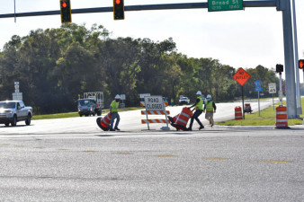 Workers remove traffic control devices to open Ayers Road on the west side of US 41 (3/9/2021 photo)