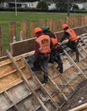 Crews construct a wall along Sam Allen Road in November 2019