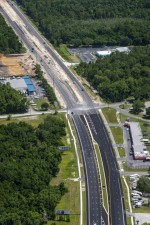 Looking north over US 19 at the split between two widening projects and storm water pond construction in the upper left of the photo (6/9/2021 photo)