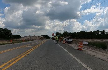 Looking south on US 301 at flagging operation for storm water pond construction and earthwork (7/17/20 photo)