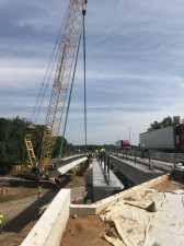 A beam is lifted into place for the widening of the ramp bridge over Sligh Avenue. (4/6/19 photo)
