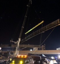 A steel bridge beam is being put into place  (1/18/2022 photo)
