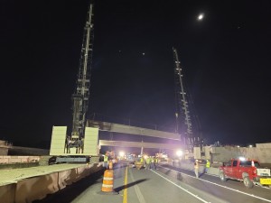 Crews place one of 5 concrete beams over southbound I-75. Each beam is 7-foot high and 163-feet long (10/16/2021 photo)