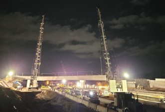 Two cranes lift the concrete beam into place (10/17/2021 photo)