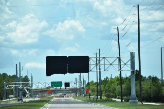 Looking west on Overpass Road where overhead signs have been installed east of Boyette Road (photo 7/6/2022)
