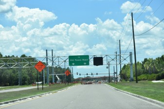 Looking west on Overpass Road where overhead signs have been installed east of Boyette Road (photo 7/6/2022)