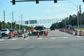 Workers finishing concrete median of Overpass Road on the east side of Boyette Road (11/1/2022 photo)
