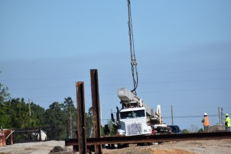 A bridge piling is offloaded on the east side of I-75 at Overpass Road (3/4/2021 photo)