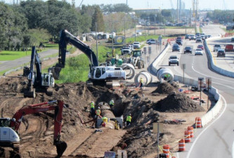 Crews install large drainage pipes along 118th Avenue east of US 19.