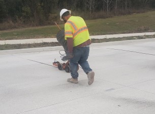Installing backer rod prior to sealing the joint in the concrete roadway (1/21/2023 photo)