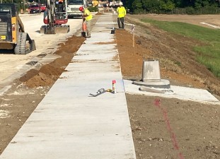 Grading slopes to place sod along the new westbound roadway, west of Fort King Road (6/20/2022 photo)