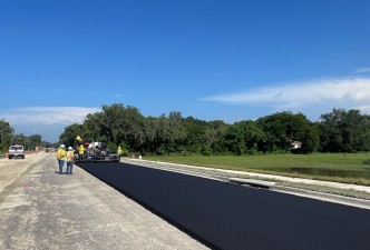 Placing asphalt along Clinton Avenue (new SR 52) west of Fort King Road (7/18/2022 photo)