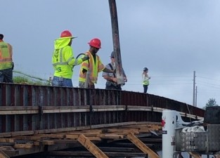 Placing concrete for bulkhead on a wall (7/2/2021 photo)