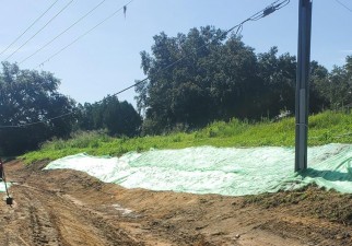 Installing erosion mat on a slope near Pasadena Road (7/27/2022 photo)