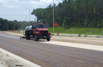 Priming completed roadway base near Smith Road before asphalt will be placed (7/27/2022 photo)